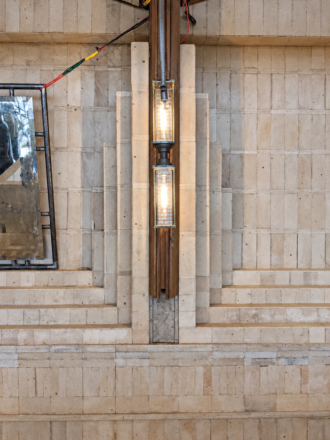 SOCIAL Vashi — Light and brick relief. A paired vertical light is tested against a stepped brick surround.
